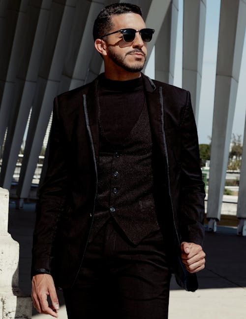 Elegant Man in a Black Suit and Sunglasses Standing Outside 