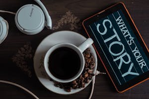 Top View Photo of Coffee Near Tablet
