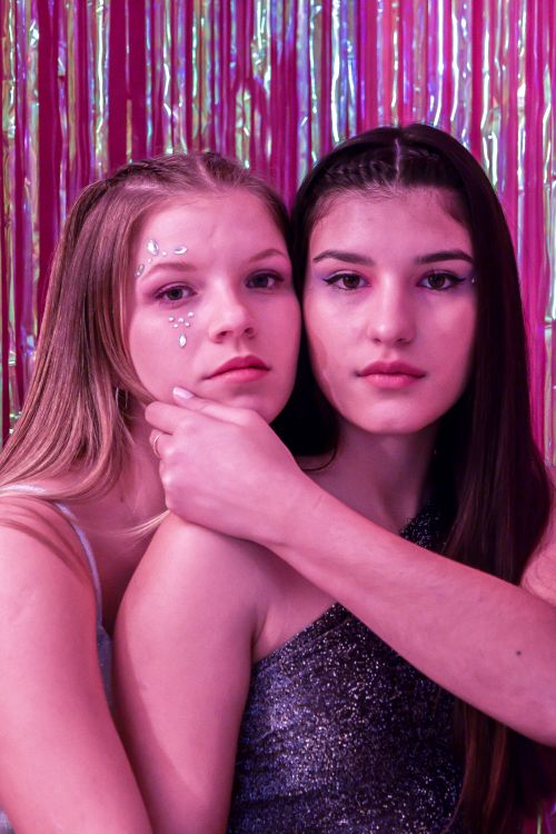 Young Beautiful Women Posing Together in Pink Light · Free Stock Photo