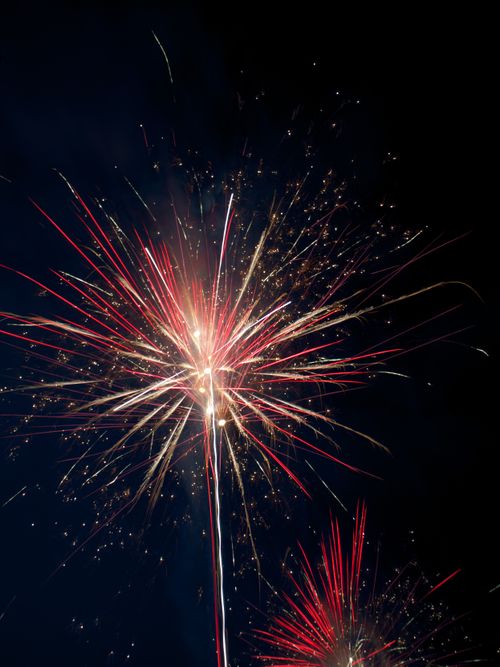 Free Explosive and colorful fireworks illuminate the night sky in a stunning celebration. Stock Photo