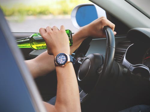 Free Person Driving and Drinking Stock Photo