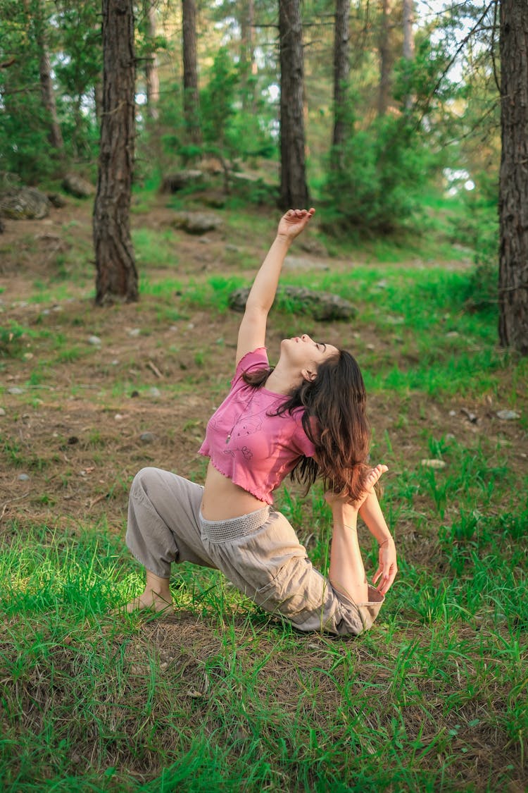 Woman Practicing Yoga In Forest