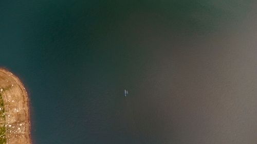 Free Drone shot capturing a canoe on a tranquil lake near Kandy, Sri Lanka. Stock Photo