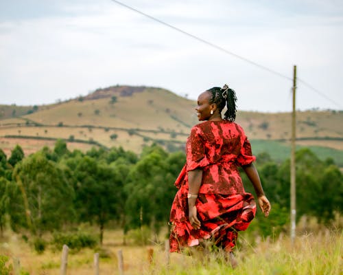Smiling Woman in Red Dress in Countryside
