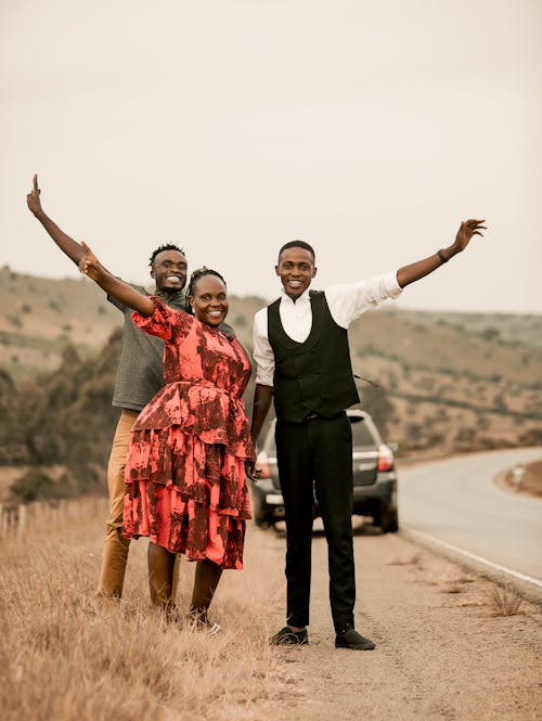 Smiling Men and Women Posing near Road