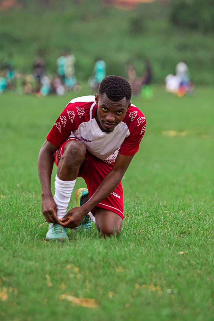 Football Player Tying Shoe