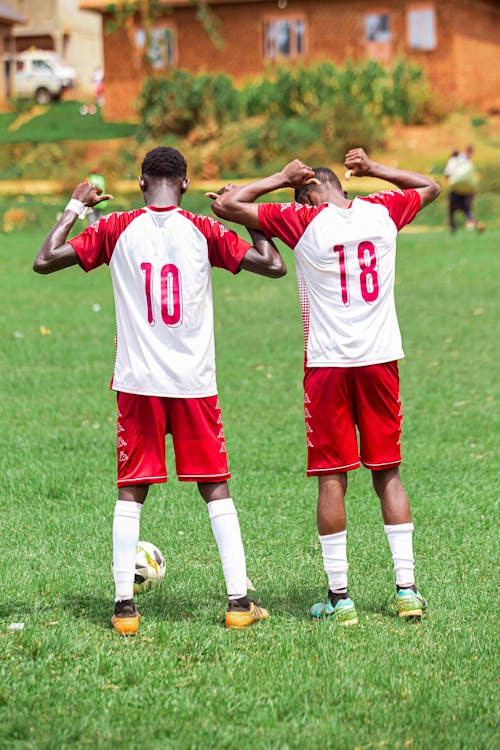 Football Players Posing on Grass