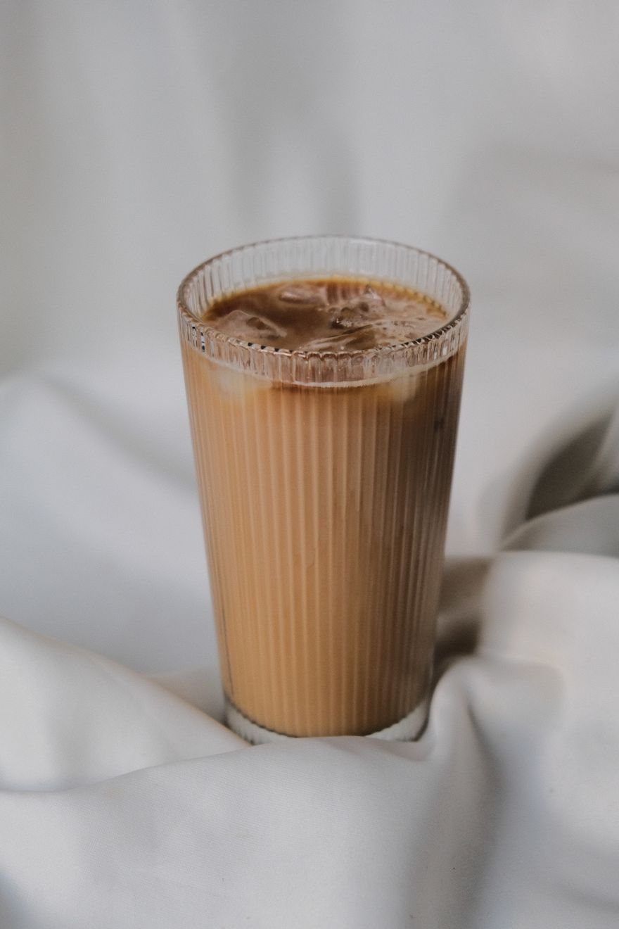 Tall glass of iced coffee on soft linen, photo by Khadijah Karaca on Pexels