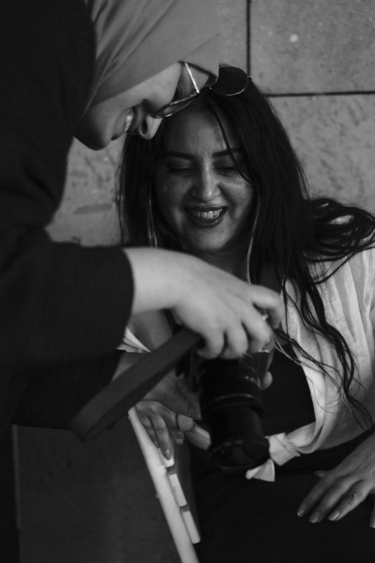 Women Looking At Photos In Black And White