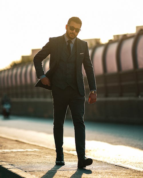 Elegant Man in Suit on Sidewalk