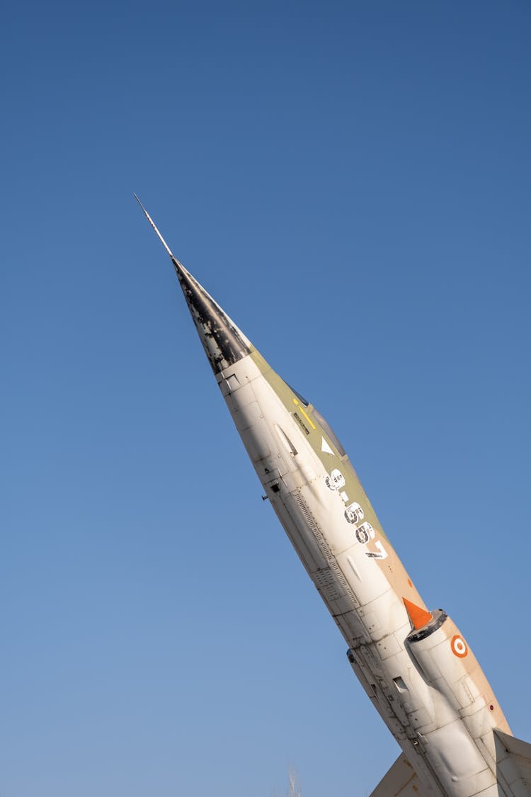 A Military Fighter Aircraft Against Clear Blue Sky 