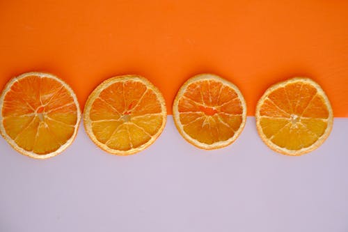 Orange Slices on White and Orange Background 