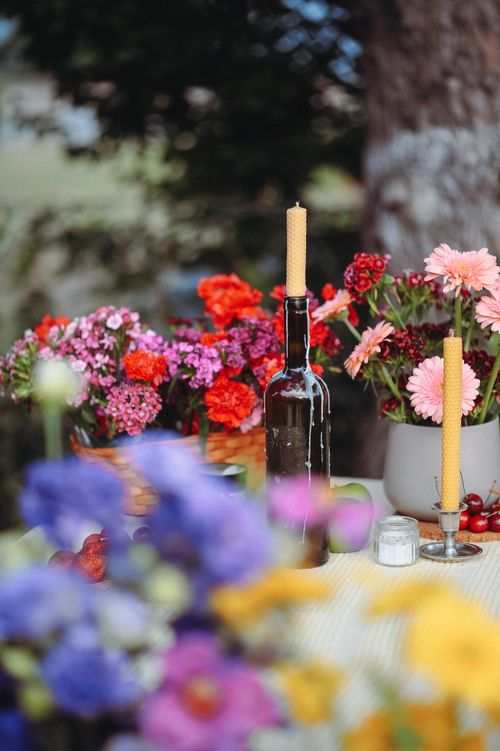 Free Colorful outdoor table setting with flowers, candles, and rustic decor. Stock Photo