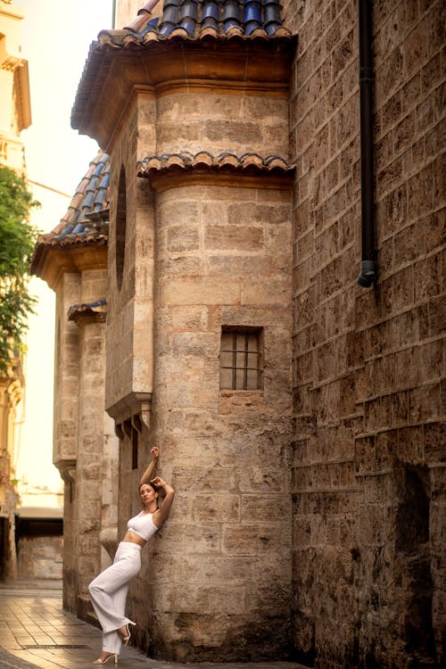 Woman Posing in Front of Traditional Building