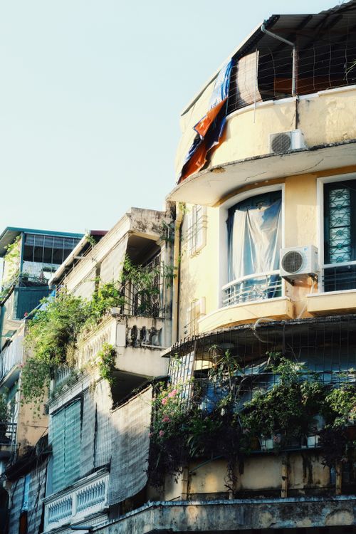 Free A vibrant streetscape featuring colorful balconies and greenery on urban apartment buildings. Stock Photo