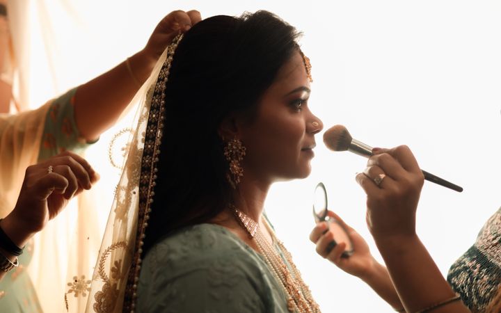 A makeup artist at work before a wedding