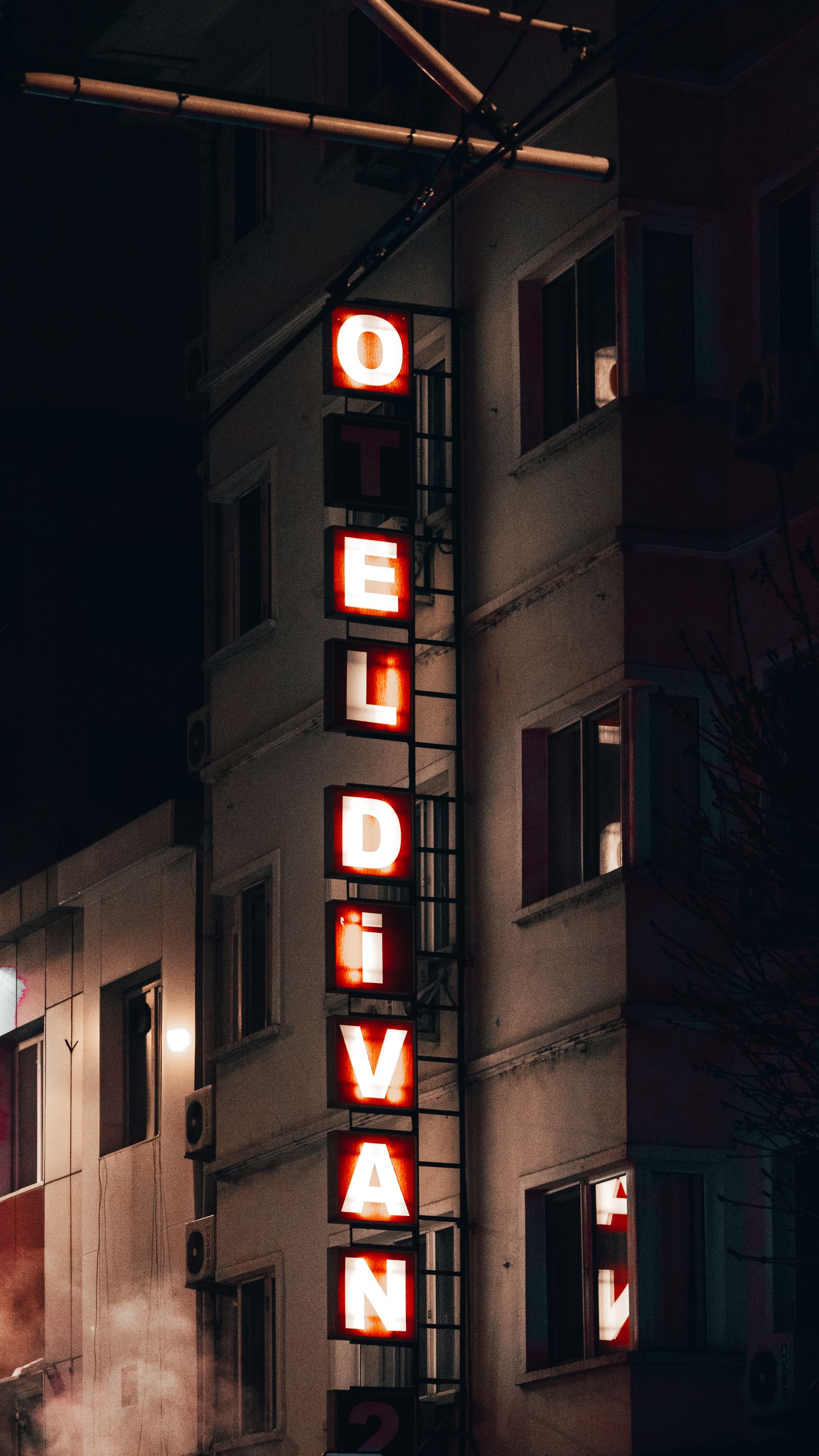Hotel exterior neon sign at night marking our location