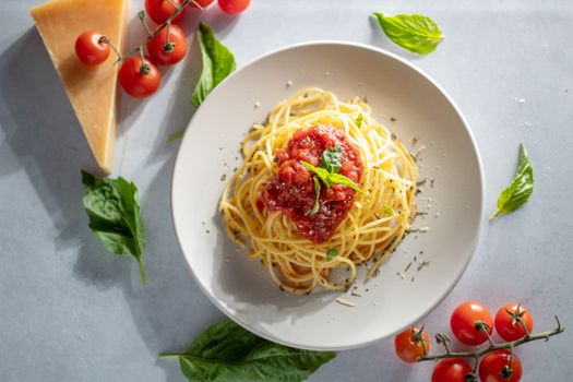 Top view of Italian spaghetti with fresh tomato sauce and basil, perfect for Italian cuisine lovers.