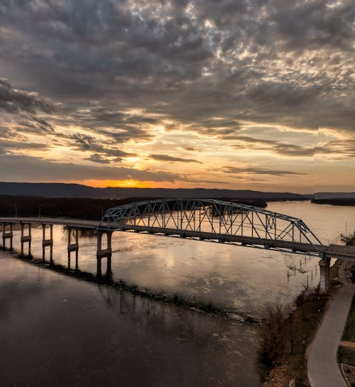 River and Bride under Dramatic Sky at Sunset