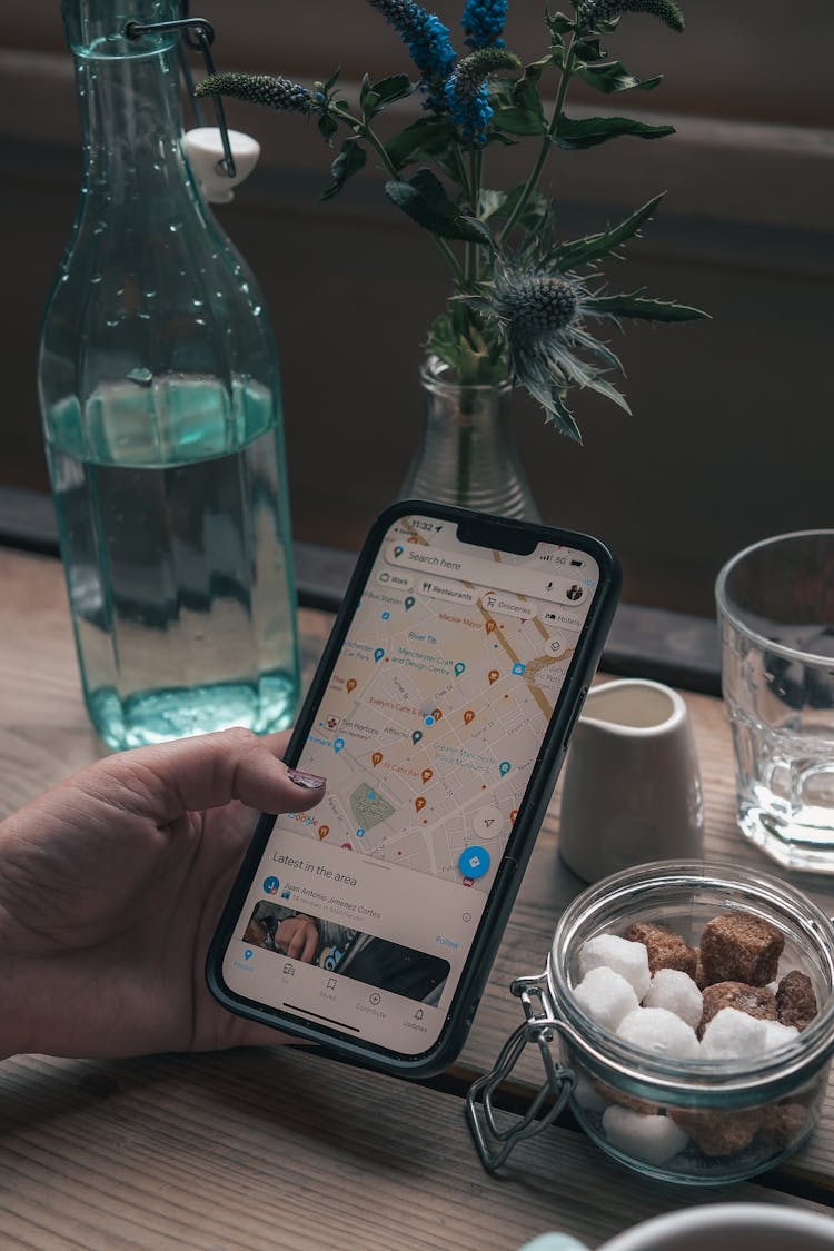 Close-up Of Woman Looking At Places On A Map On Her Phone 