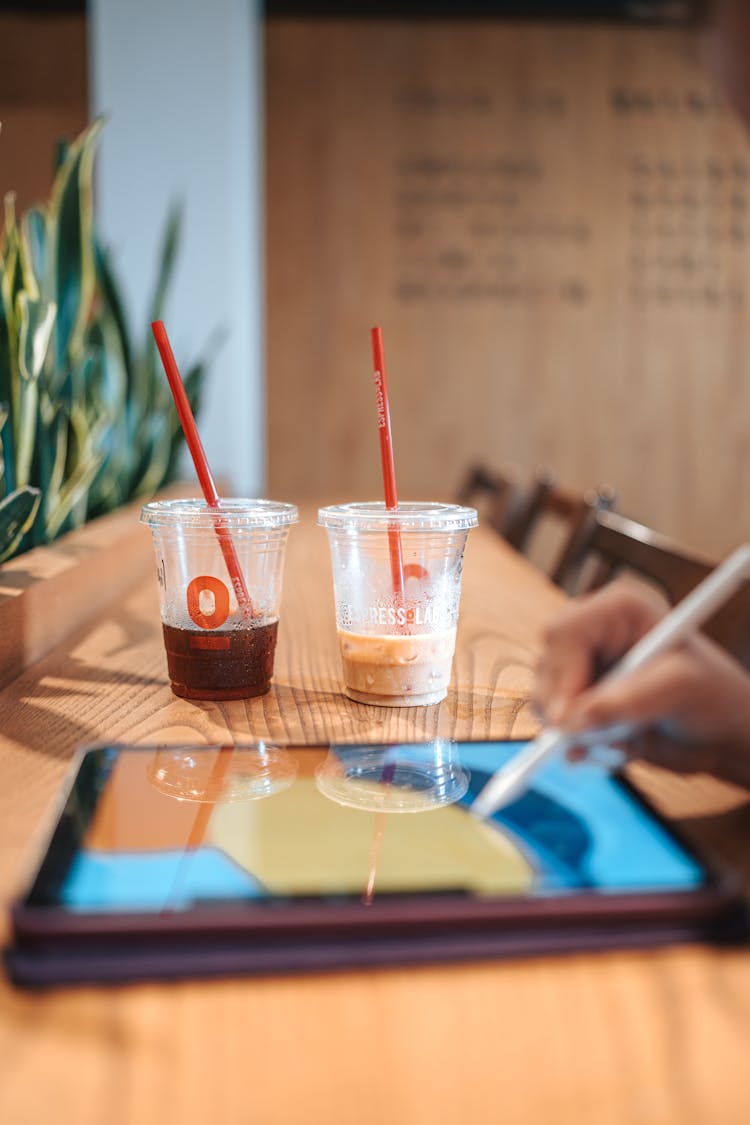 Close-up Of A Person Drawing On A Tablet 