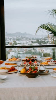 Elegant table setting with diverse appetizers against a cityscape backdrop, perfect for leisure dining.