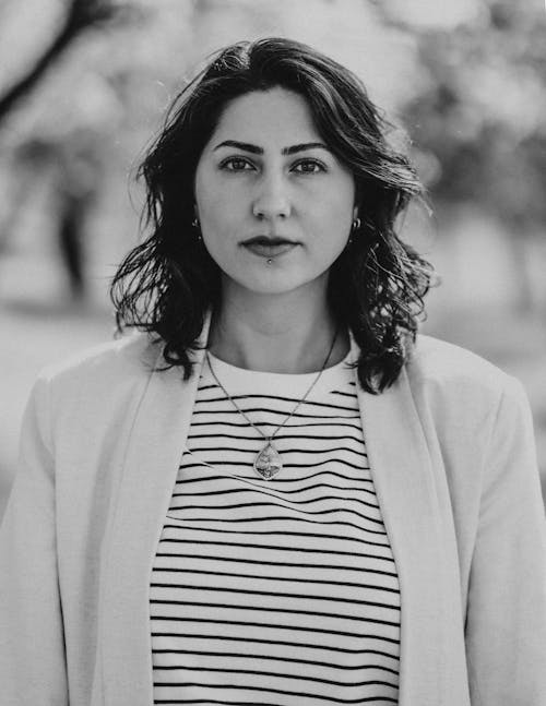 Black and White Portrait of a Young Brunette Woman in Cardigan and Striped T-Shirt