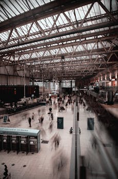 Motion blur of commuters in the bustling Liverpool train station.