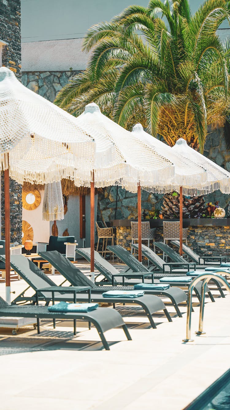 Row Of Beach Loungers And Umbrellas