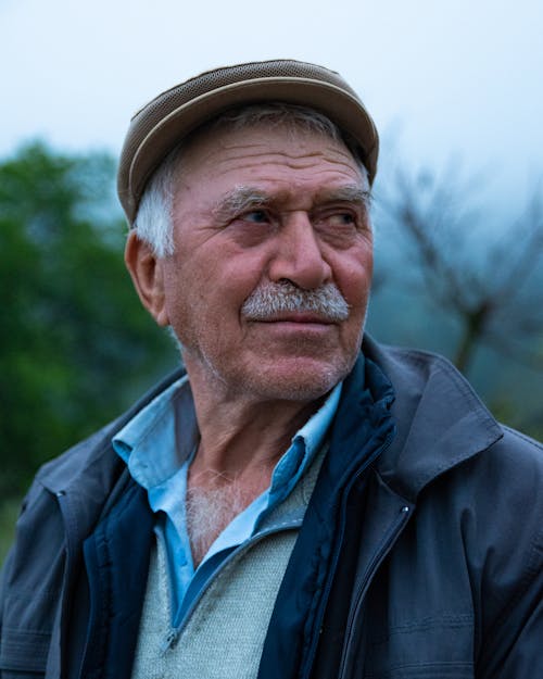 Portrait of an Elderly Man with Gray Mustache Standing Outside 