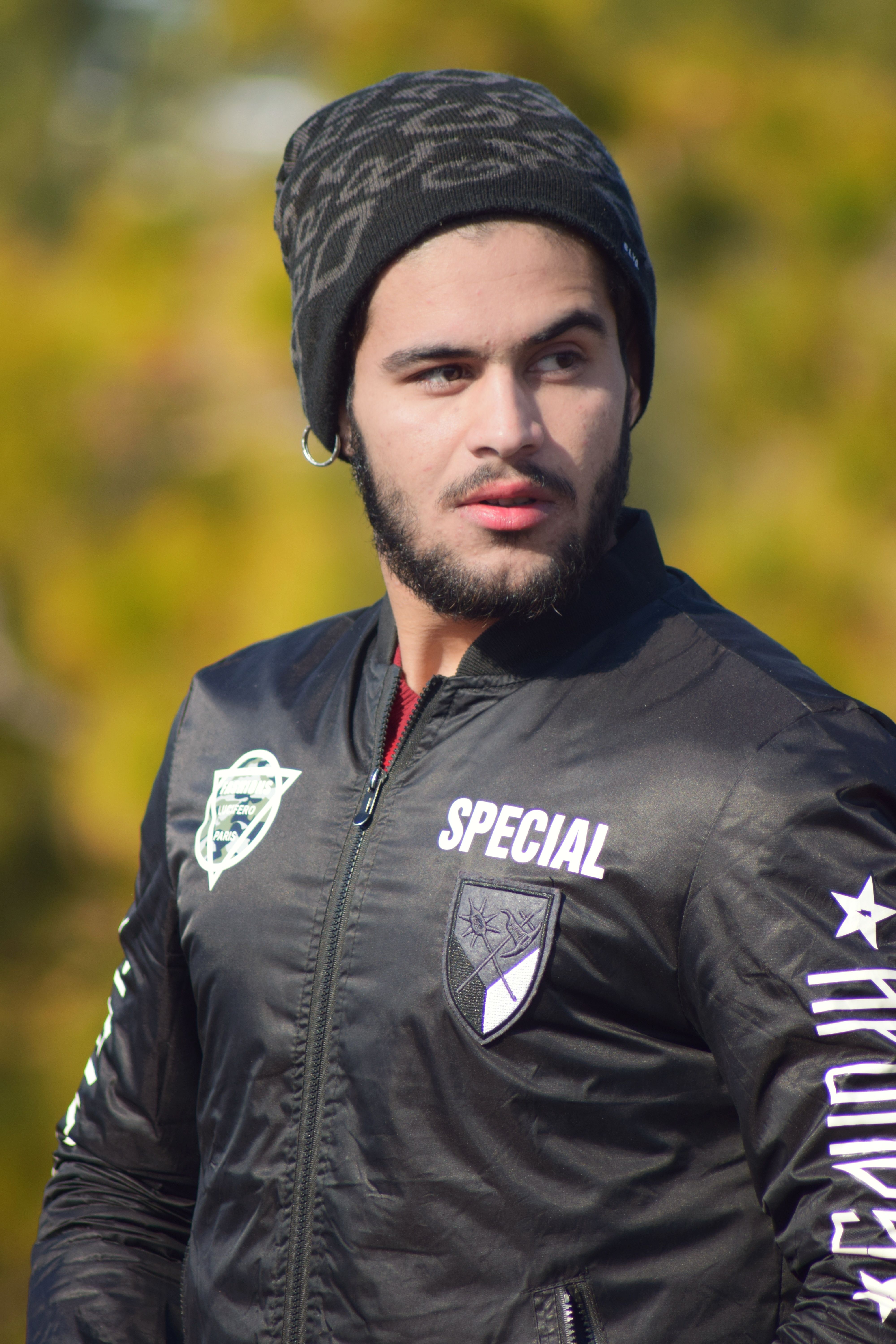 Close-up of a fashionable young man with a beard and beanie in Murree, Pakistan.