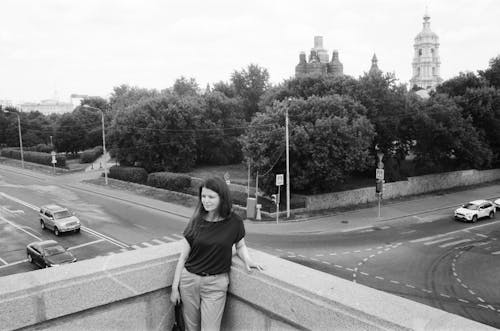 Woman Standing in Front of a Street in Black and White