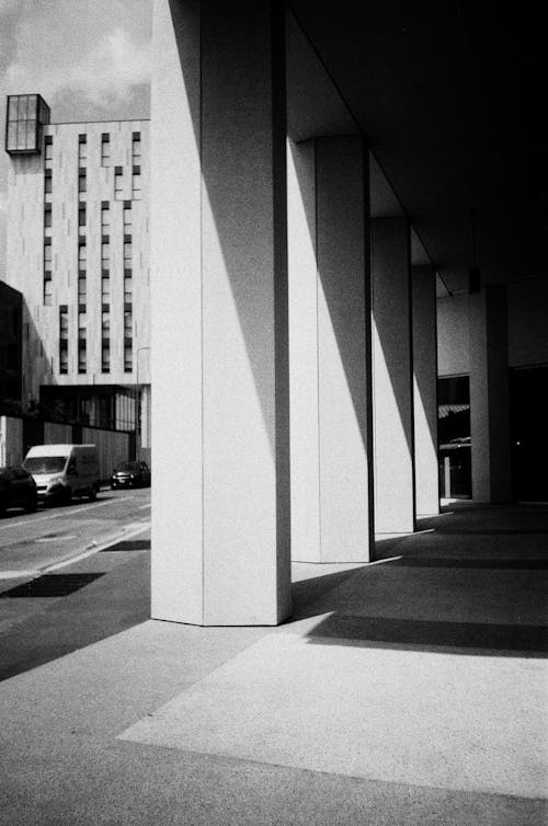 Black and White Picture of a Pavement and Columns of a Building in City 