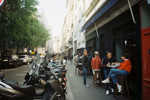 People Sitting in a Restaurant by the Street