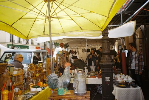 Free Bustling city market under yellow umbrellas, showcasing diverse local goods. Stock Photo