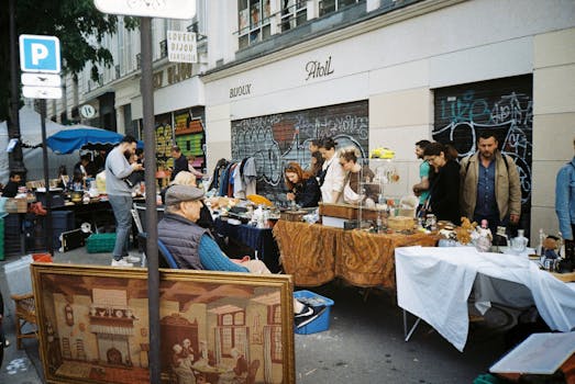 Explore a bustling urban flea market with various stalls, antique goods, and engaged shoppers.
