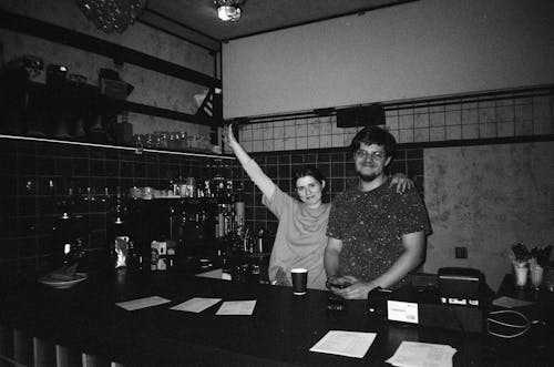 Smiling Woman and Man Standing by Counter