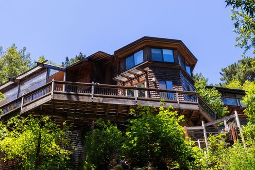 Charming wooden villa surrounded by lush greenery, showcasing traditional architecture.