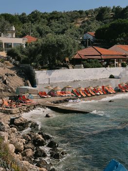 Charming Mediterranean beach scene with vibrant umbrellas and serene waters.