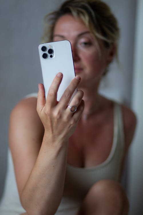 A woman taking a selfie with her phone