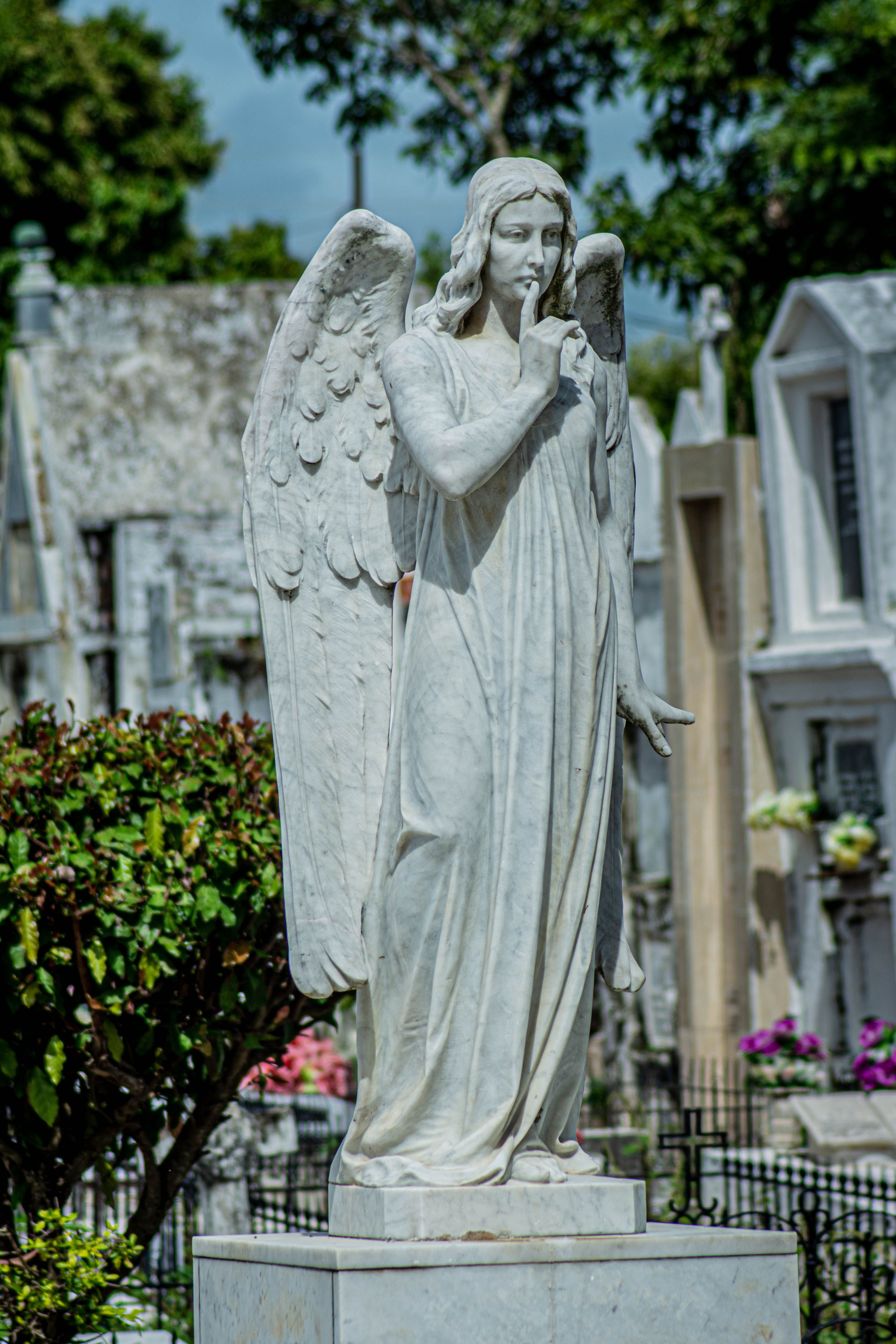 Sculpture of an Angel with his Head Resting on a Tree Stump by the Sea ...