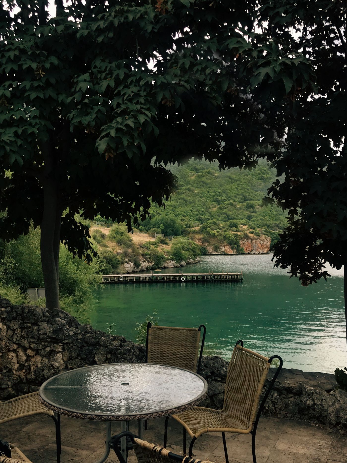 Outdoor table and seating beside calm water
