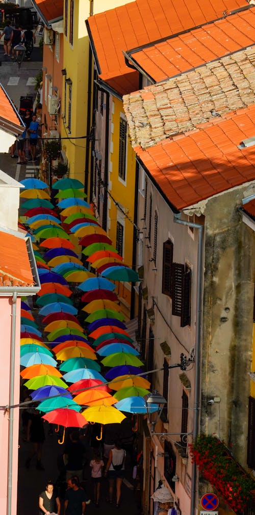High Angle View of Colorful Umbrellas over a City Street 