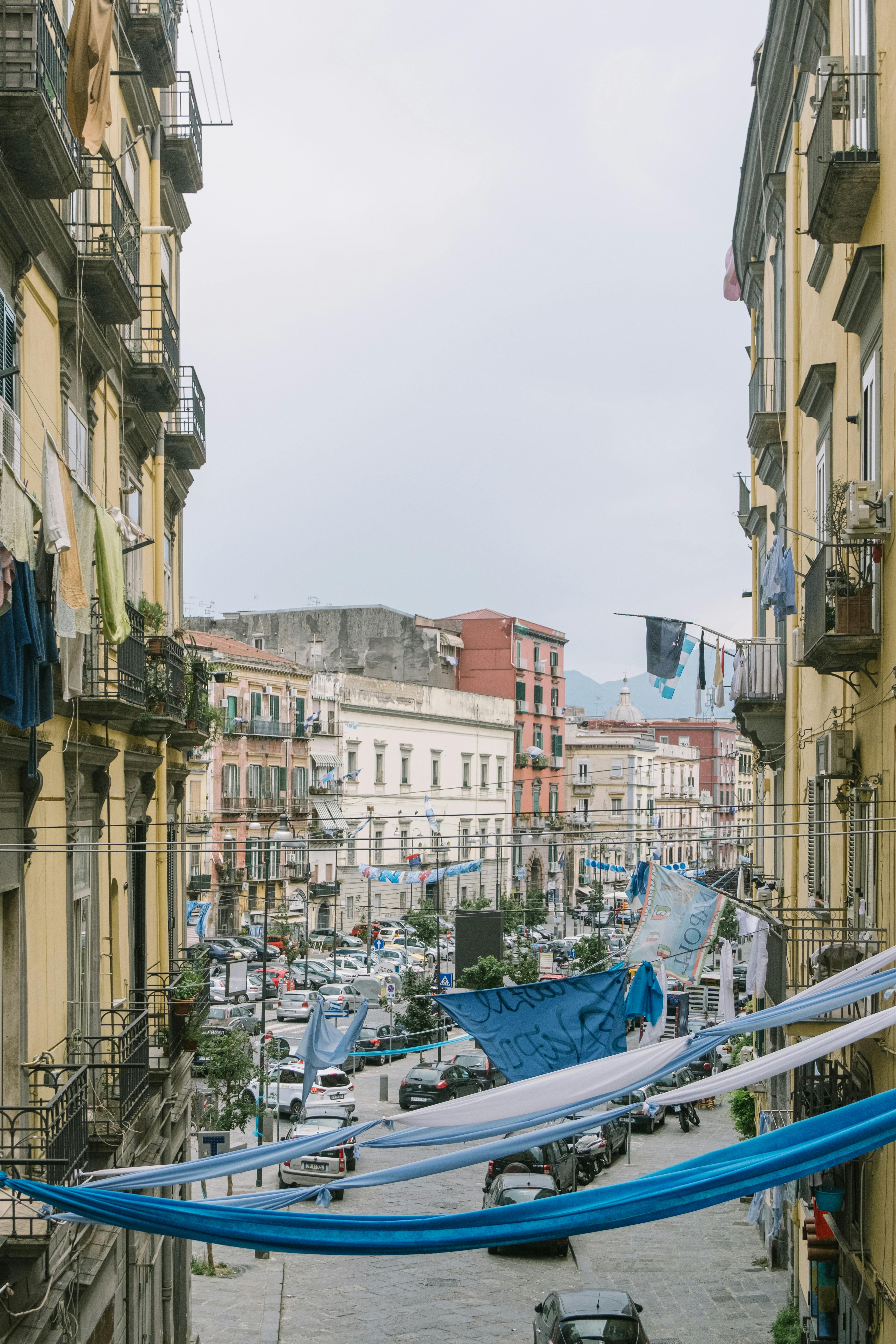 A picturesque street in Naples, showcasing vibrant urban life and historic architecture.