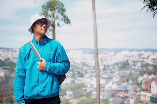 Man Wearing White Bucket Hat And Blue Zip-up Jacket