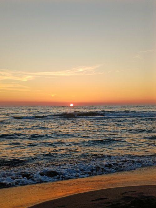 Free Peaceful sunset over the Albanian coast with gentle waves and vibrant colors. Stock Photo