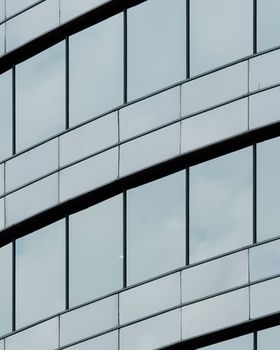 Close-up of a modern glass facade highlighting urban architecture style.
