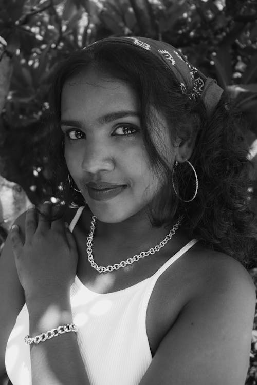 Black and White Photo of a Young Brunette Woman Wearing a Chain Link Necklace and Bracelet