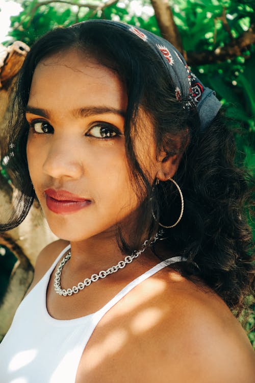 Beautiful Brunette Woman Wearing a Silver Chain Link Necklace and Hoop Earrings