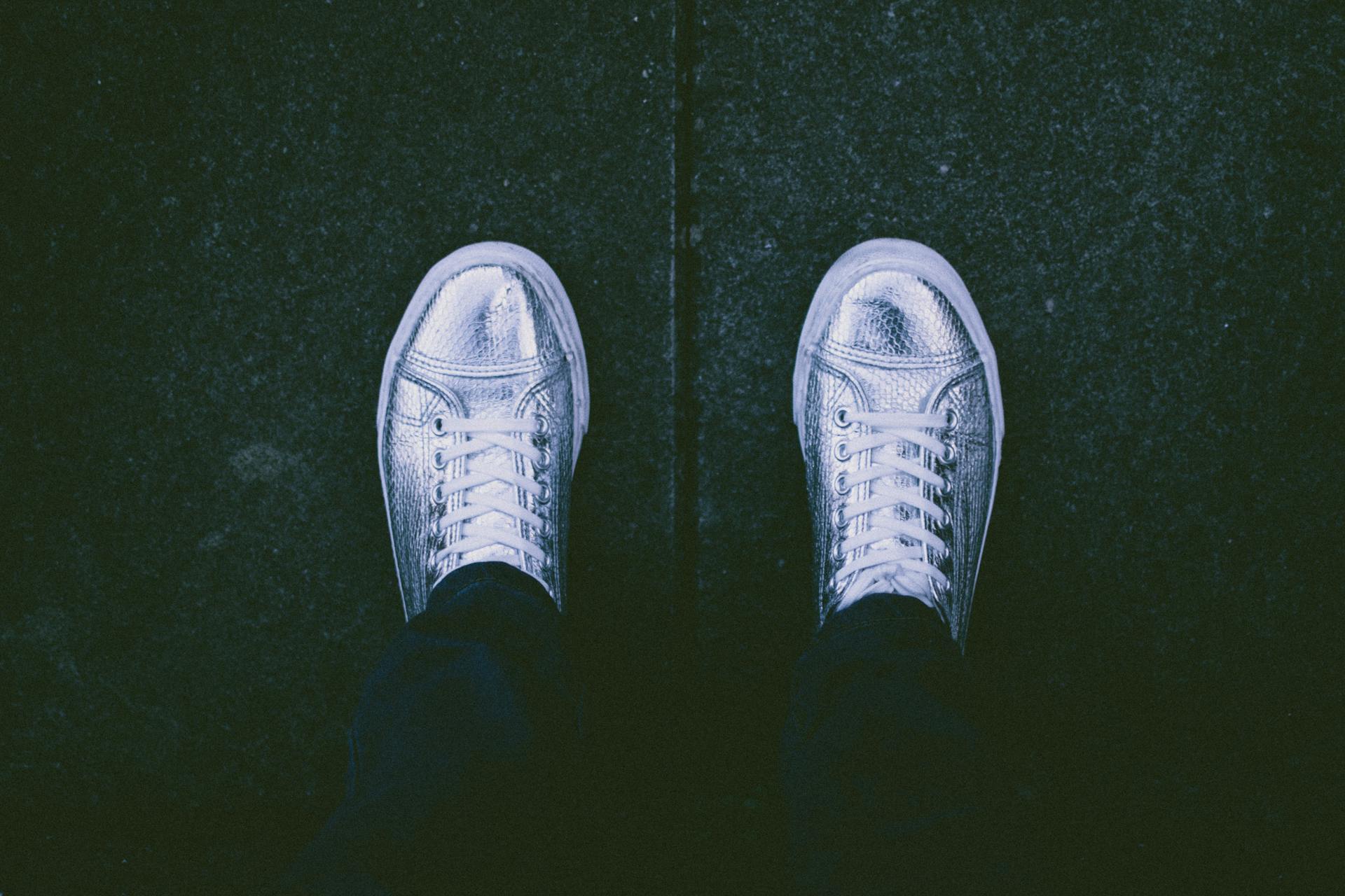 Top View Photo of Person Wearing Silver Shoes